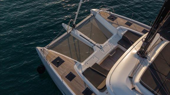 Among catamaran rental options in Kastela Princess Karla front net area and seating spaces are seen anchored in calm sea
