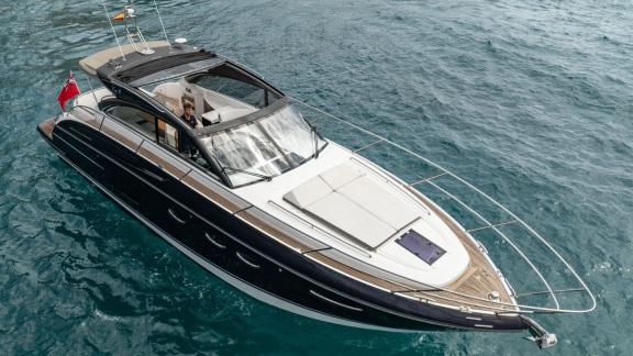 Among Monaco daily yacht charter options Belle Vie motor yacht shows bow sunbathing area on open sea.