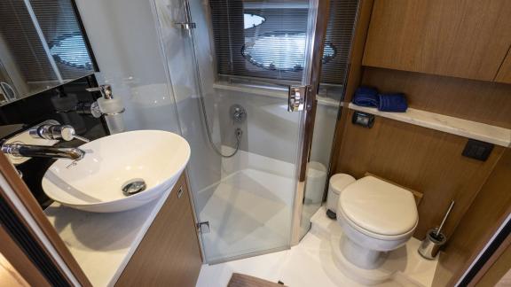 Among Monaco daily yacht charter options Belle Vie motor yacht shows bathroom with shower sink and toilet for comfort.