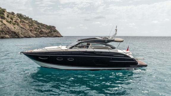 Among Monaco daily yacht charter options Belle Vie motor yacht shows smooth cruising with coastal scenery.