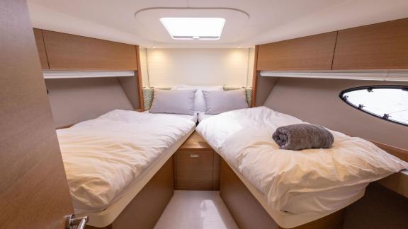 Among Monaco daily yacht charter options Belle Vie motor yacht shows cabin with separate twin beds for guests.