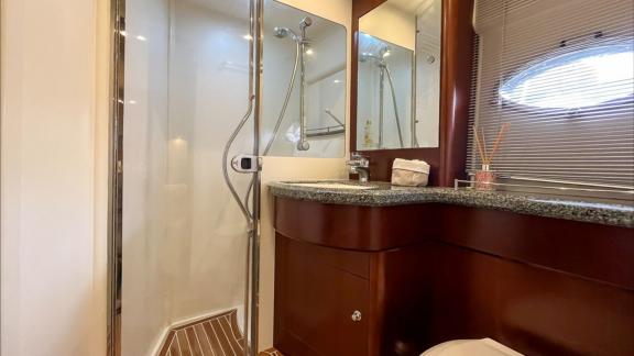 Among Monaco daily yacht charter options Nous motor yacht shows bathroom with shower cabin and sink.