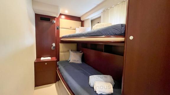 Among Monaco daily yacht charter options Nous motor yacht shows cabin with bunk beds for practical accommodation.