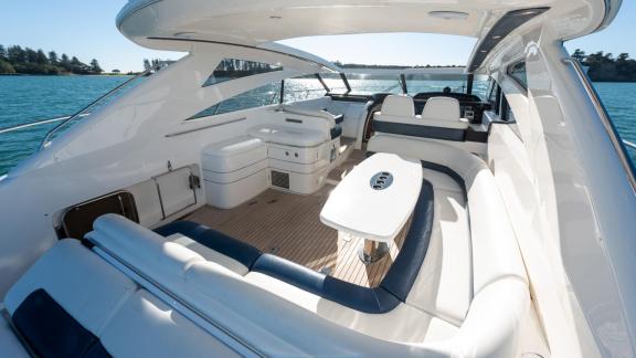 Among Monaco daily yacht charter options Nous motor yacht shows cockpit with seating area and table.
