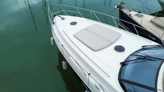 Among Monaco yacht rental options Nous motor yacht shows front deck sunbed area from top view in marina.