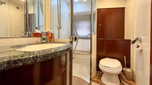 Among Monaco daily yacht charter options Nous motor yacht shows bathroom with shower cabin and toilet.