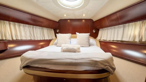 Among Monaco daily yacht charter options Nous motor yacht shows cabin with large bed and bright interior design.