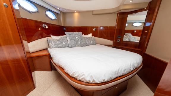 Among Monaco daily yacht charter options Nous motor yacht shows cabin with large double bed for relaxation.