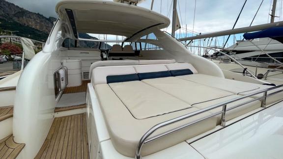 Among Monaco daily yacht charter options Nous motor yacht shows aft deck with large sunbed for relaxation.