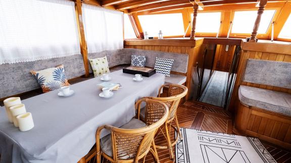 Tastefully decorated interior of Gulet Pronto White with a dining table and comfortable seating areas.