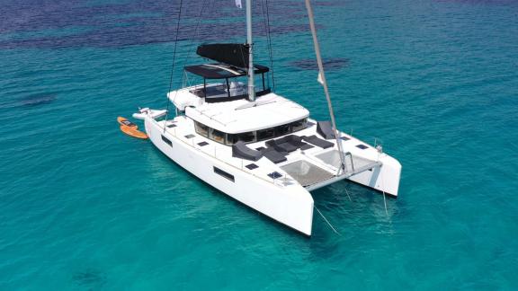 The Lagoon 52 Queen of Diamonds is peacefully anchored in the crystal-clear waters of the Aegean Sea.