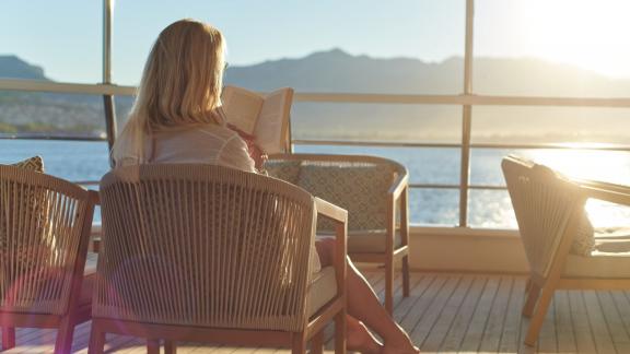 Peaceful reading time on the yacht's deck with stunning sea views.