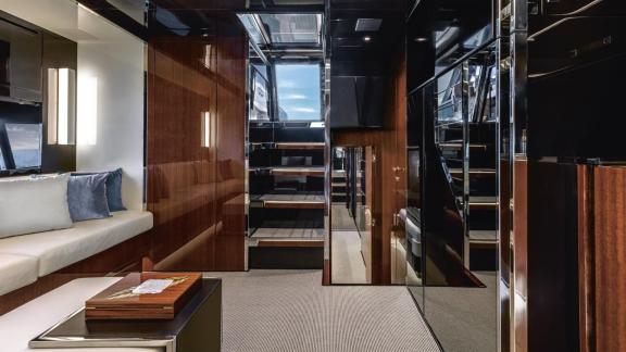 Among Monaco daily yacht charter options Vera motor yacht shows interior corridor with stairs and modern design.