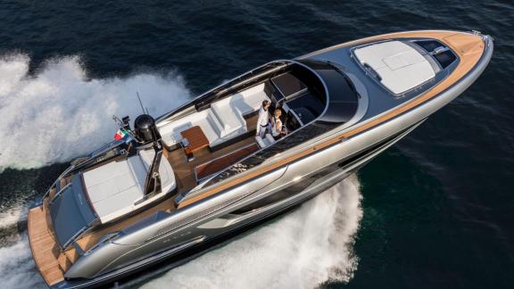 Among Monaco daily yacht charter options Vera motor yacht is seen from above cruising fast on open sea.