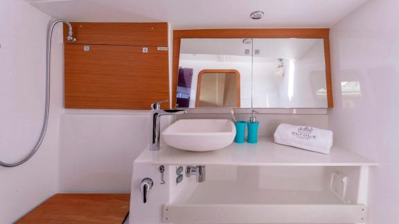 Modern bathroom on the sailing yacht Sam's Wind with a stylish sink and large mirror.