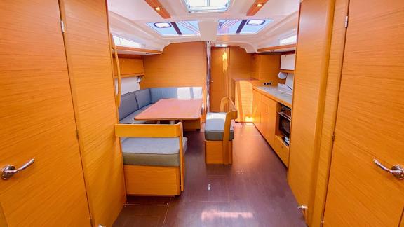 Bright salon of the sailing yacht Sam's Wind with a spacious seating area and kitchen.