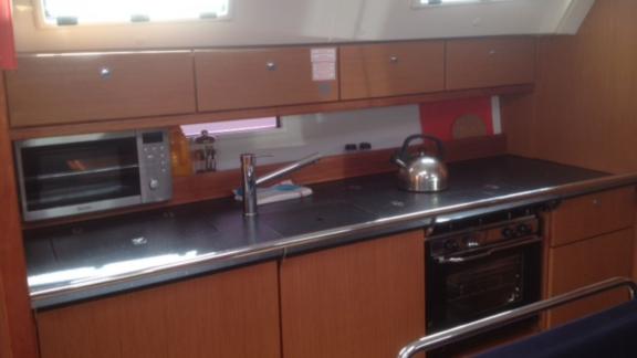 The kitchen area of sailing yacht Almina features modern appliances and a spacious countertop.