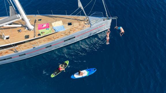 Bellkara sailing yacht Conrad YCC91 offers paddleboarding and water fun on the crystal sea.