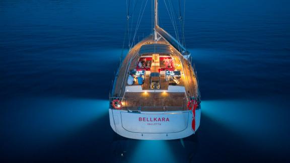 The sailing yacht Bellkara built by Conrad Shipyard YCC91 offers stylish illuminated cruising in deep blue sea at night.