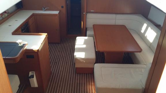 The interior of sailing yacht Diagoras features a cozy salon and fully equipped kitchen, ideal for bareboat charter.