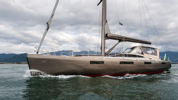 Gigreca sails in cloudy weather with a sleek hull gliding steadily on the water.