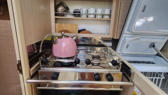 The galley of Lima yacht includes a stove and a kettle.