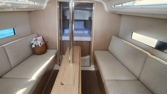 Spacious living area of the Lima yacht with a bedroom in the background.