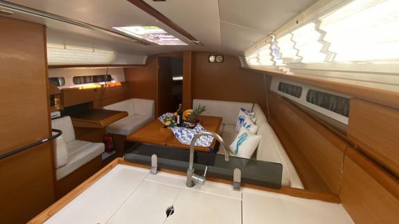 The saloon of the Mercann sailing yacht offers a spacious seating area and a modern kitchen.