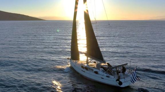 Yannis 65S luxury sailing yacht sailing at sunset in Greece.