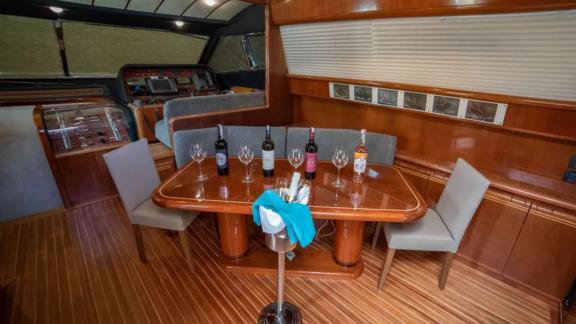 Elegant dining table in the interior of the Hurrem motor yacht, set with wine and glasses.