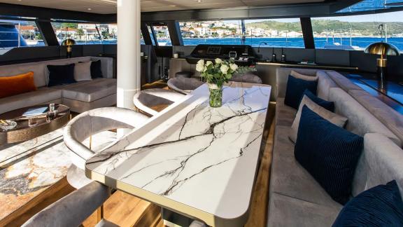 The Sunreef 60 Mr. Si features a spacious salon with a marble dining table and panoramic views all around.
