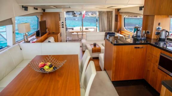 Kitchen and dining area with sea view on the Midnight Summer Dream yacht.