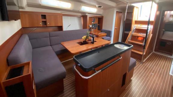 The living area of Kia Ora features stylish furniture and comfortable seating for an enjoyable stay at sea.