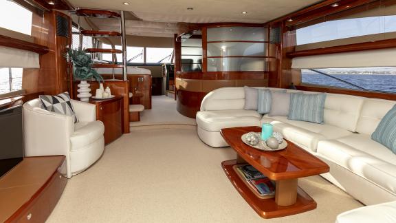 The salon of the yacht Azure features modern furniture, a spacious seating area, and a sea view.