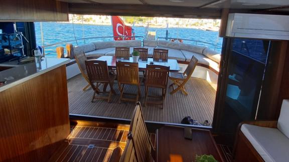 The dining area and lounge on Gulet Life is Life seamlessly connect indoor and outdoor spaces with a sea view.