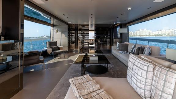 The stylish and spacious lounge on San Lorenzo Sx88 combines comfort with the joy of daily yacht rental in Dubai.