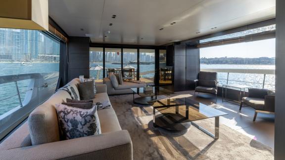 The spacious lounge of San Lorenzo Sx88 is perfect for enjoying the view during hourly yacht rental in Dubai.