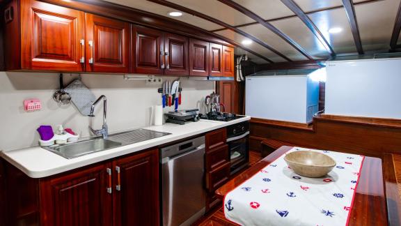 Fully equipped kitchen of the 24-meter Gulet Sani Kaptan 2 with modern appliances and ample storage in Bodrum, Turkey.