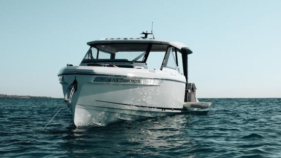 Motor yacht Bali with a modern hull design rests on the calm water.