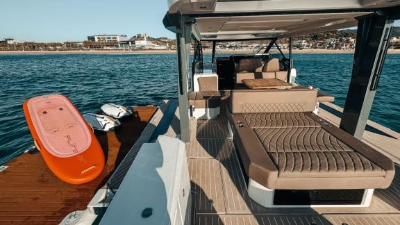 The aft deck of motor yacht Bali is equipped with spacious seating and sea scooters for water sports.