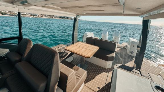 The comfortable seating area on motor yacht Bali’s aft deck offers a relaxing experience with ocean views.