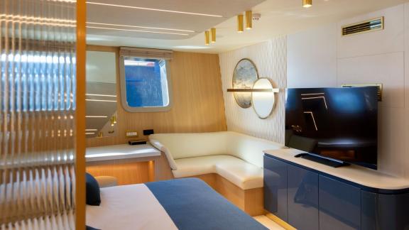 Scorpios Motorsailer features an L-shaped sofa, work desk and TV unit in this modern cabin.