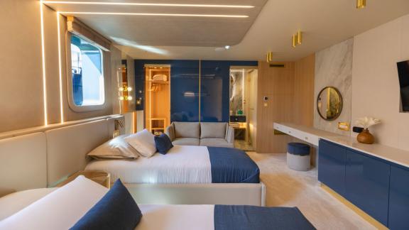 Scorpios Motorsailer features twin beds, a seating area and direct access to a private bathroom.