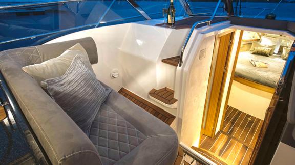 The luxurious cabin entrance area of motor yacht 7 Happy days stands out with comfortable seating and stylish stairs.