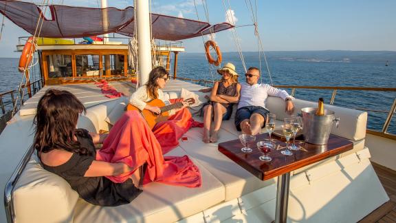 Guests enjoy music and drinks on the Gulet Altair, yacht in Split, Croatia, 6 cabins, luxury sailing holiday.