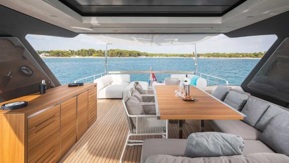 Cozy sun deck of motor yacht Secundus with seating and dining area, Split, Croatia.