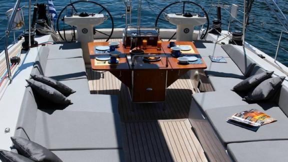 The aft deck of the luxury yacht Shooting Star in Greece features a comfortable seating area and dining table.