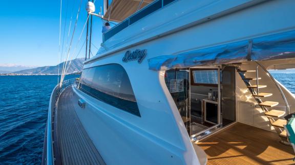 View along the side deck of the Gulet Destiny with the sea horizon in the background.