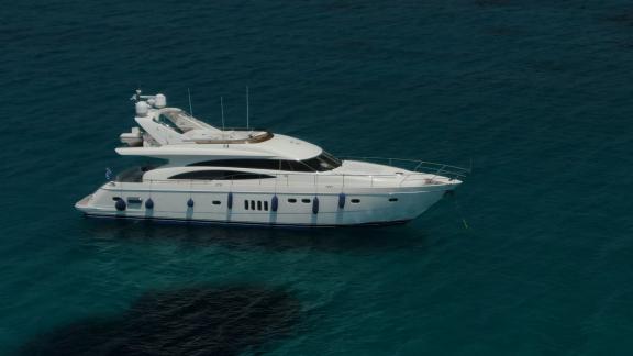 The yacht Azure is peacefully anchored in the middle of the turquoise sea.