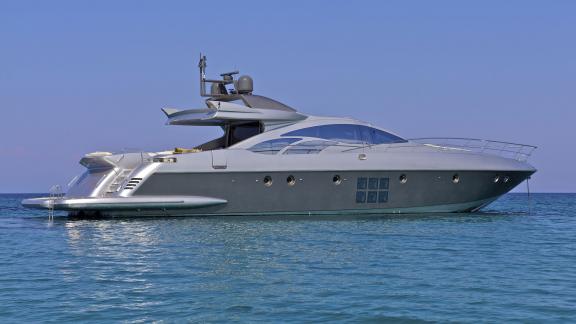 The elegant motor yacht Thea Malta in front of the beautiful Greek islands. Perfect for exclusive journeys.